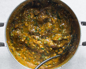 Overhead view of nigerian ogbono soup in a pot, top view of ogbono draw soup with assorted meats in a soup pot, flatlay of nigerian ogbono and okra soup