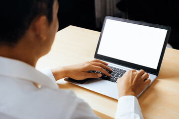 Business person or office worker using laptop computer while sitting at desk. uds