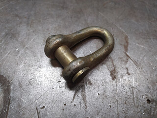 The bracket is iron. Industrial crane, stroply tool, work at the factory, lifting crane, fasteners.