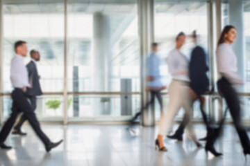 business people walking in the corridor of an business center, pronounced motion blur, crowded...