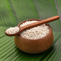 Starch tapioca pearls in the bowl and spoon - Manihot esculenta.