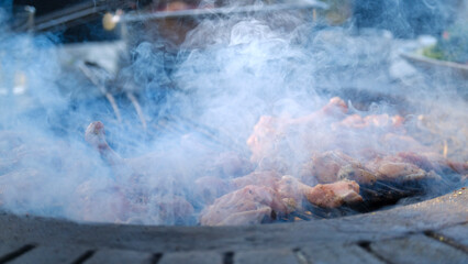 The appetizing appearance of meat grilling on a barbecue in a picnic setting on a summer day