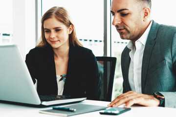 Businessman executive is in meeting discussion with a businesswoman worker in modern workplace office. People corporate business team concept. uds