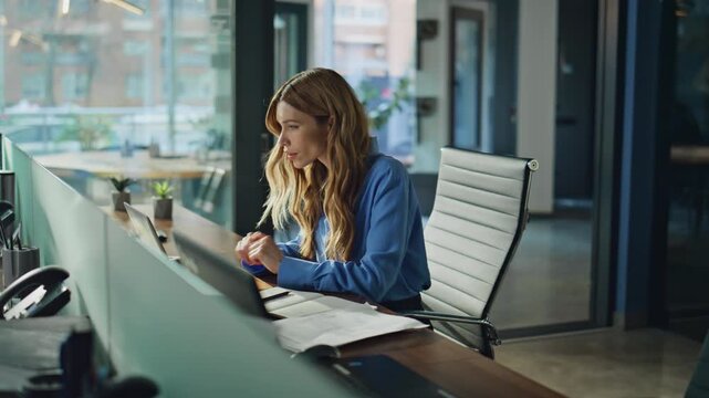 Serious businesswoman typing computer focusing on business project at office 