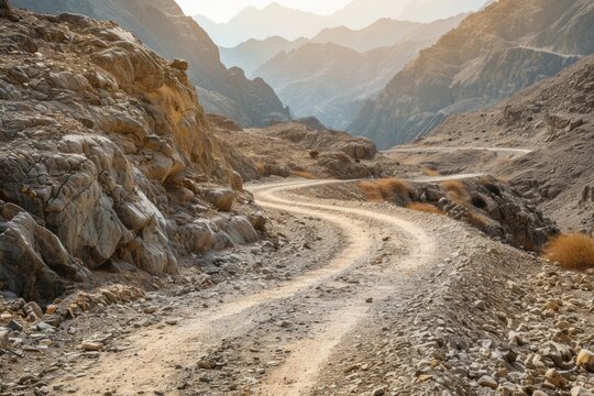 A scenic dirt road winds through the mountains