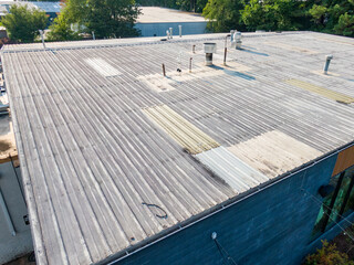Fototapeta premium Daytime Drone Images of an Old Metal Roof on a Commercial Building