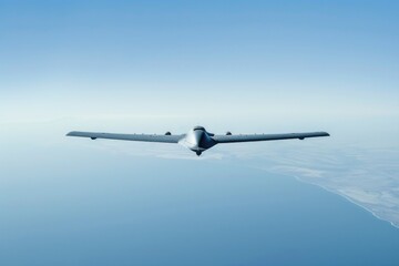 Naklejka premium A small airplane flies over a large body of water, great for use in travel or adventure-themed designs