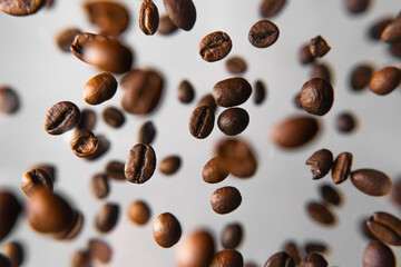 coffee beans in the air falling on a white background