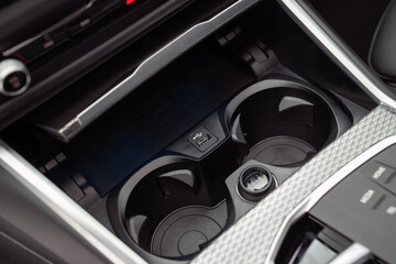 A high-quality image of a car cup holder inside a modern car
