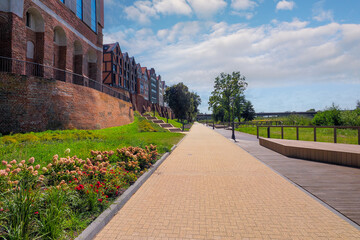 Malbork, Poland - a promenade along the Nogat River near the Teutonic Castle, on the right the rebuilt municipal public library in the former Latin school  © janmiko