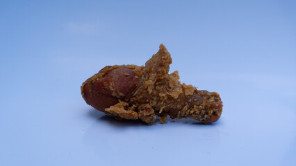 Crispy Delight: Close-Up of a Golden-Brown Fried Chicken Drumstick on a Light Background
