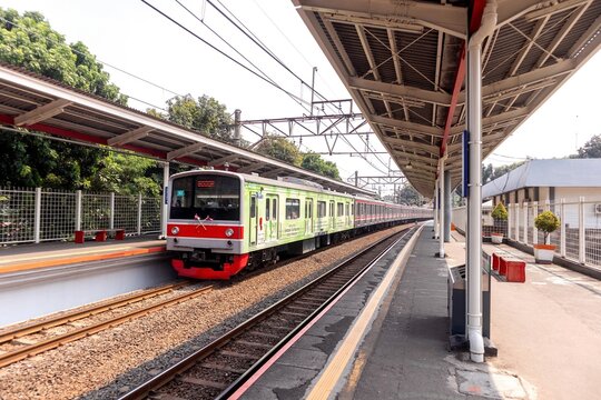 Jakarta, Indonesia - August 10, 2024: A commuter line train arrives at Lenteng Agung Station. Mass public transportation in Jakarta.