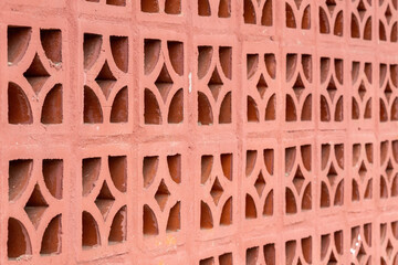 Repeating diamond pattern in red brick. Abstract background. Close-up of aesthetic red clay bricks...