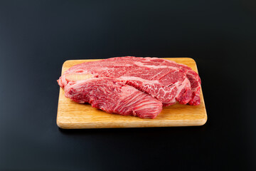 Sliced ​​beef on a black background