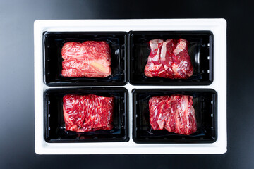 Sliced ​​beef on a black background