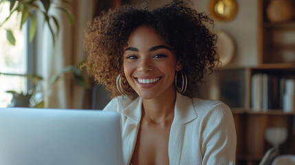 Beautiful young woman in business suit sitting at desk..