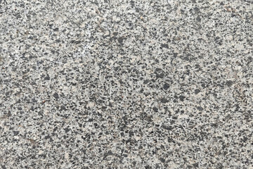 Concrete texture. Pebbles of different colors and signs of aging are visible.