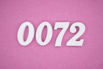 The numbers are made of white painted wood. Laying on the floor was pink paper.