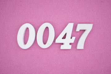 The numbers are made of white painted wood. Laying on the floor was pink paper.