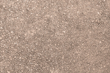 Concrete texture. Pebbles of different colors and signs of aging are visible.