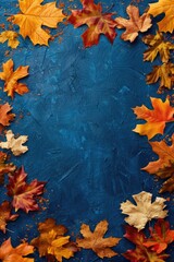 A vibrant display of autumn leaves covering a blue surface