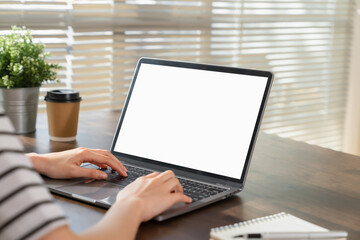 Woman hand using laptop and type on the keyboard, Mockup screen of advertisement.