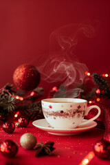 Fototapeta premium Christmas toy made from a fragrant cup of coffee, holiday concept with steaming coffee on a red background