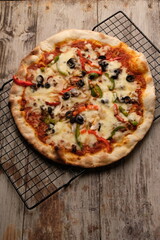 Pizza is a savory dish from Italy, a type of round, flat dough, which is baked in the oven and usually covered in tomato sauce and cheese with other additional food ingredients.