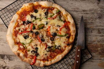 Pizza is a savory dish from Italy, a type of round, flat dough, which is baked in the oven and usually covered in tomato sauce and cheese with other additional food ingredients.