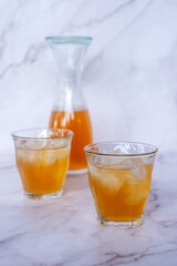 Two glass of homemade Kombucha on the marble table, healthy fermented tea beverages.