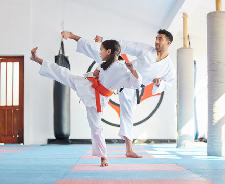Kid, master or kick in martial arts dojo for training, fighting exercise or karate club education. Learning skill, practice or judo teacher with girl child in studio for taekwondo lesson or workout