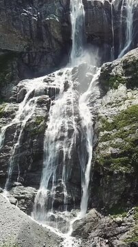 Close-up raging mountain waterfalls. Aerial view of giant waterfall flowing in mountains. Beautiful landscape