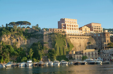Fototapeta premium View of Sorrento from the sea at sunset, Campania, Italy