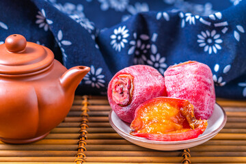 Close up of traditional Chinese food, Fuping persimmon cakes from Weinan, placed on bamboo rafts