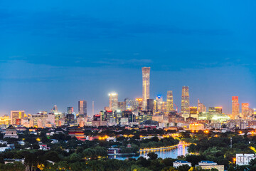 Fototapeta premium High angle night view of Guomao CBD and Bell and Drum Tower in Beijing, China