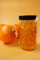 Delicious and Zesty Orange Marmalade Made from Fresh Oranges on a Vibrant Background