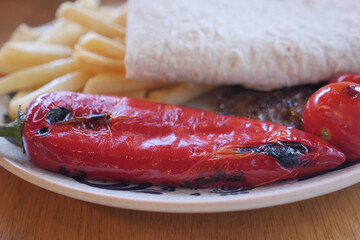 Deliciously Grilled Red Pepper Served with Various Tasty Sides and Fresh Tortilla Bread