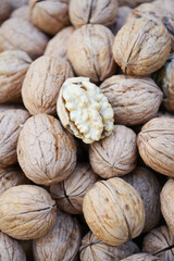 stack of natural walnuts selling at shop 