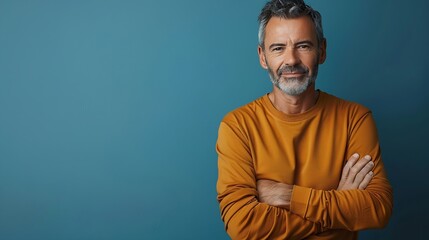 Fototapeta premium Handsome middleaged man standing with his arms folded looking at camera and smiling Halflength front portrait against blue background with copy space : Generative AI