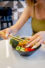 woman eating salad in restaurant
