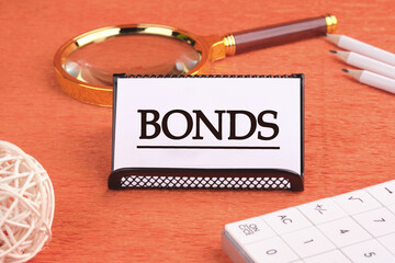 BONDS word on a white card on a black stand