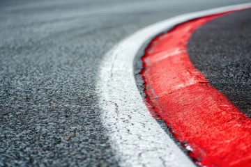  Curving red and white kerb on race track detail Motorsports circuit close up © VolumeThings