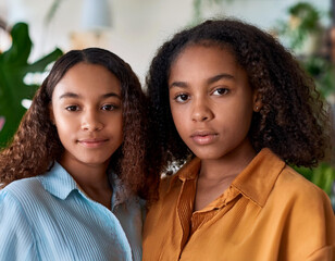 Close-Up Portrait of Mixed, Biracial, and Diverse Sisters Embracing Their Unique Bond in a Natural, Indoor Setting
