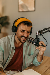 Man hosting a podcast from his living room, surrounded by equipment