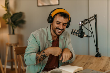 Man hosting a podcast from his living room, surrounded by equipment