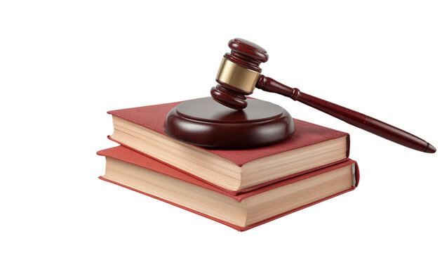 A legal gavel resting atop stacked law books, symbolizing justice and the legal system in a courtroom setting.