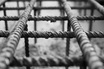 Metal rods reinforcing concrete