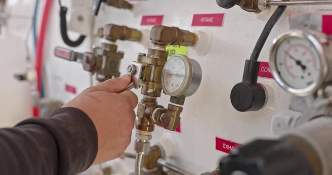 Man operating valves on hyperbaric chamber close up
