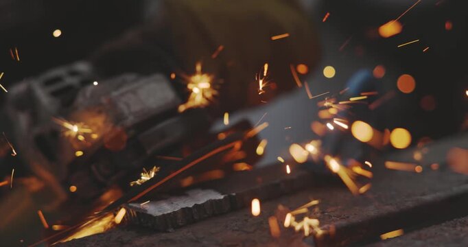 Sparkling cutter intensely slicing through metal closeup