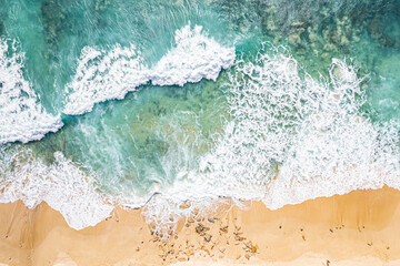 Aerial View of Waves Crashing on Sandy Shore
